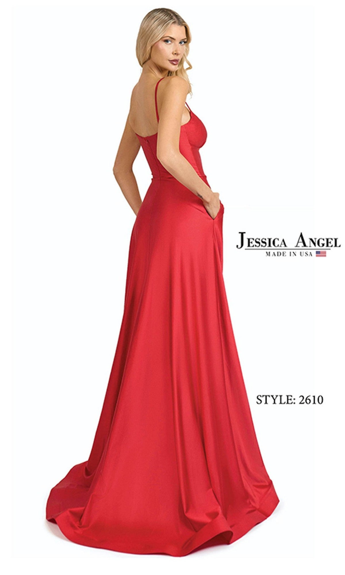A woman poses with her back slightly turned in the Long Prom Dress: Jessica Angel 2610, a sleeveless, floor-length red gown that stands out against a white background.